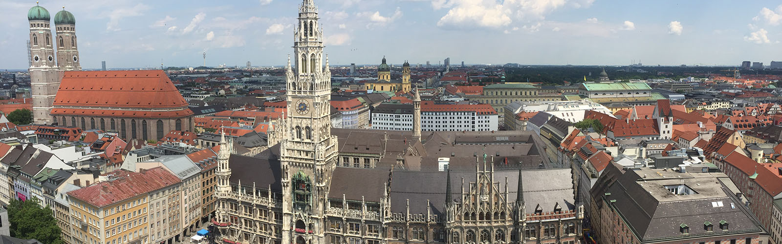 Skyline view of Munich with the cathedral as the focal point. The rest of the city is surrounding the cathedral with unique red roofs.
